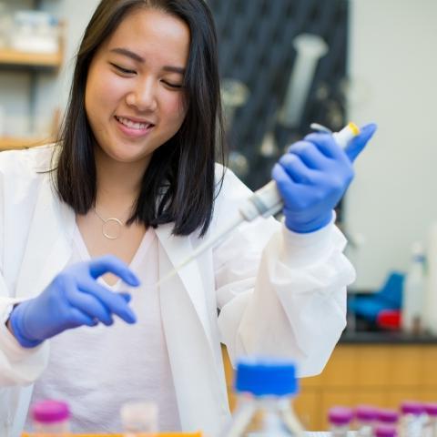 Student injecting fluid into beaker