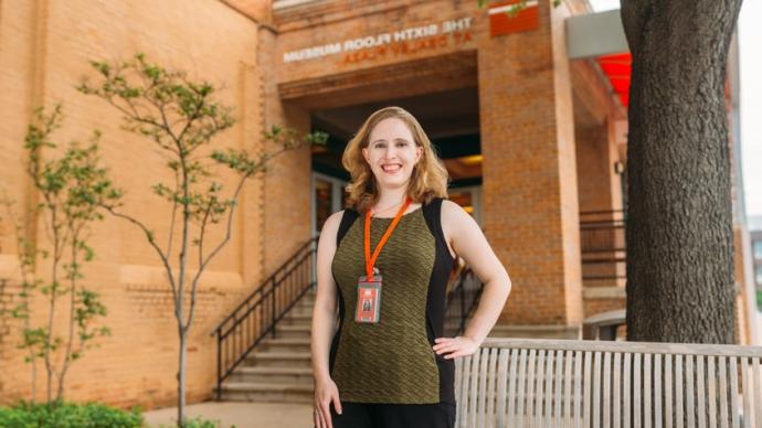 Alumna Stephanie Allen at the entrance of the Sixth Floor Museum