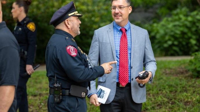 Lorenzo Sanchez standing outside on 赌博娱乐平台网址大全 campus with a TUPD officer