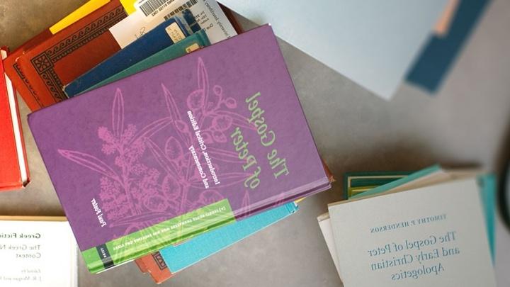 overhead view of books stacked on a table.