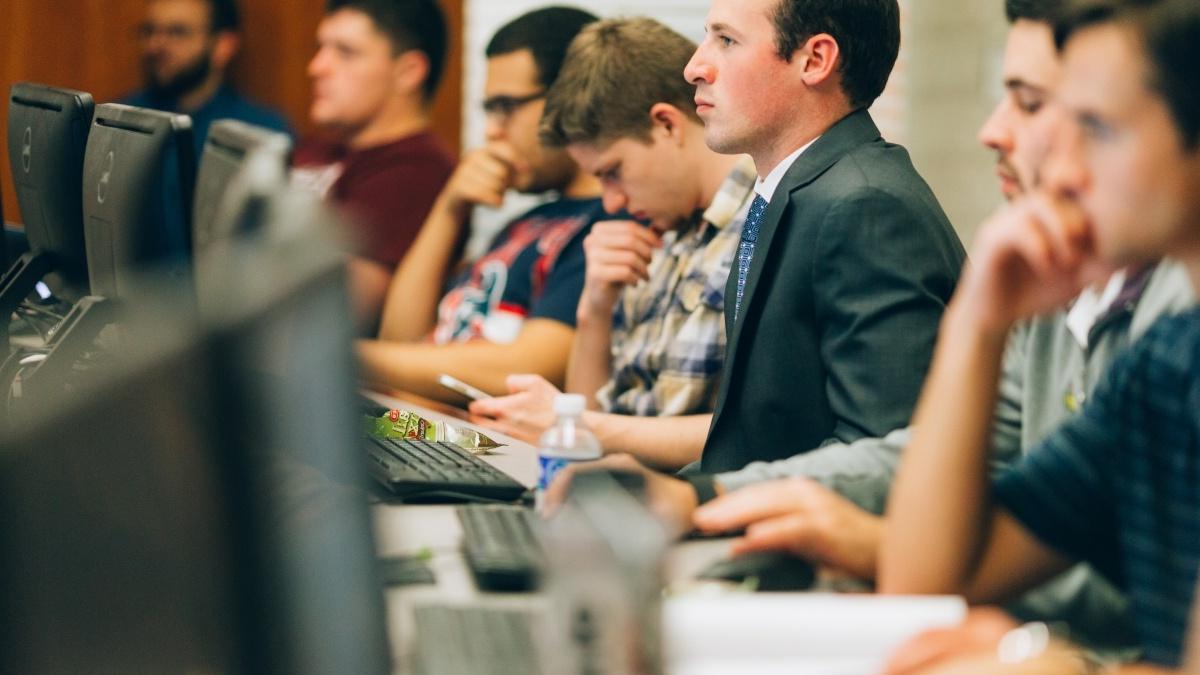 Students sitting at computers listening to lecture